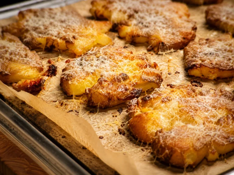 Golden crispy Parmesan smashed potatoes on a baking tray